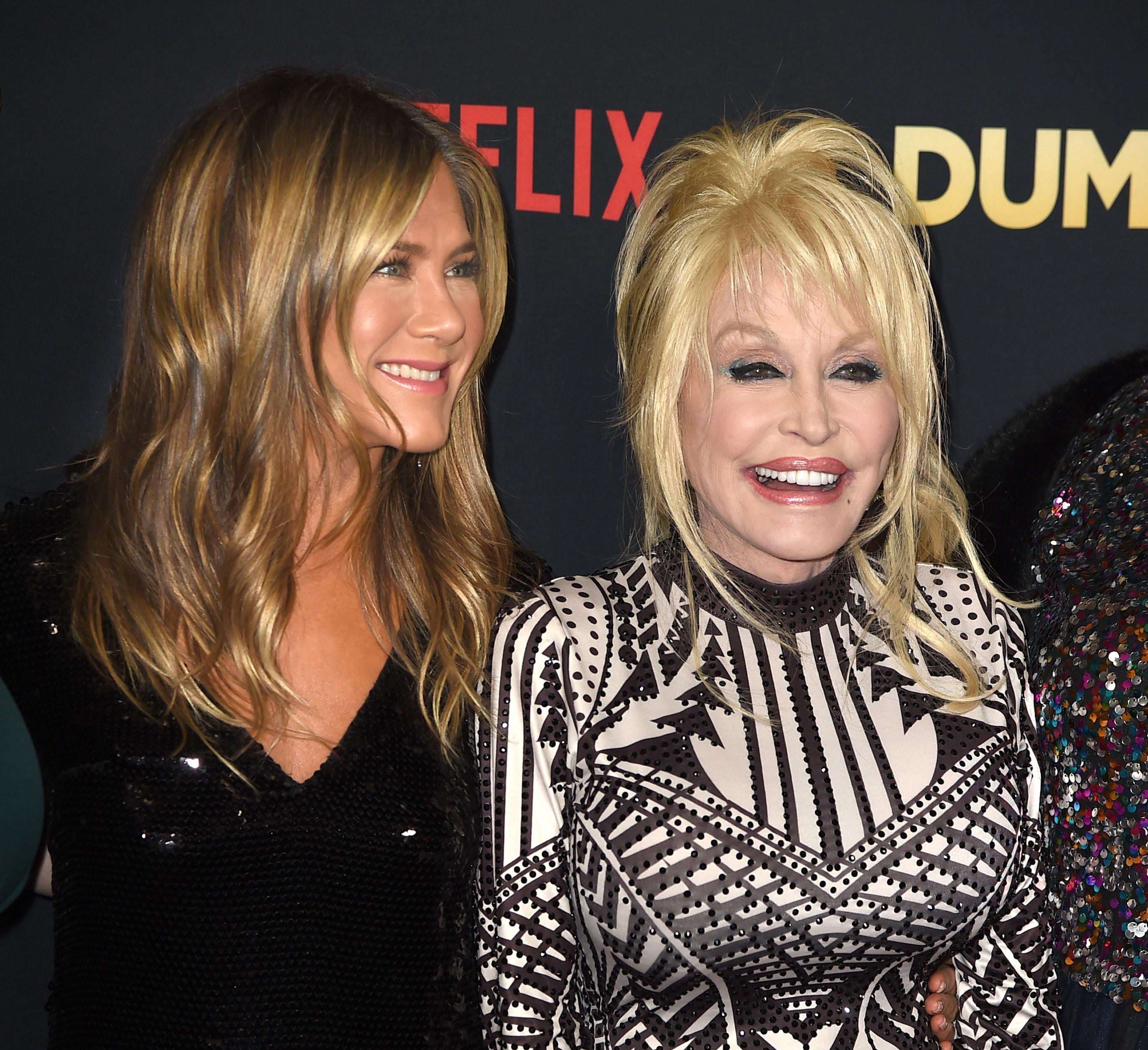 Friends actor Jennifer Aniston wears a black dress, and Dolly Parton wears a black-and-white dress.