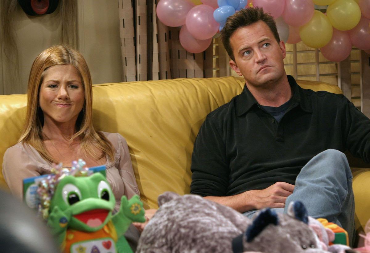 Jennifer Aniston makes a funny face as she sits with co-star Matthew Perry in between takes on the set of hit NBC series